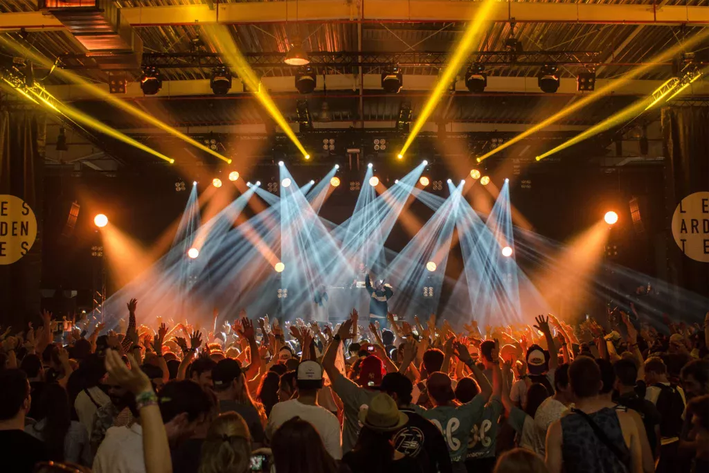 Live concert with dramatic lighting and engaged audience